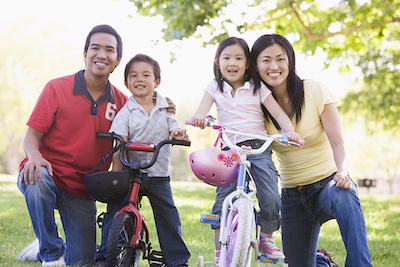 Families With Children On Bikes Outdoors Smiling satisfaction guaranteed